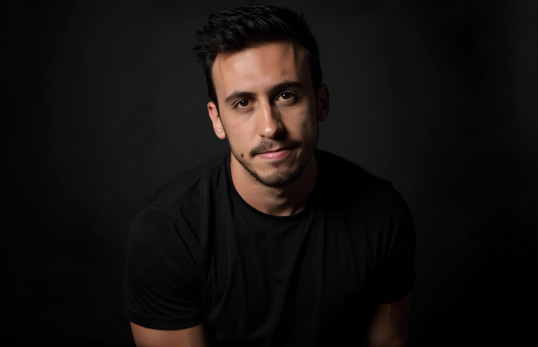 Alberto Conceição, founder of ALC Media, in a black t-shirt against a dark background